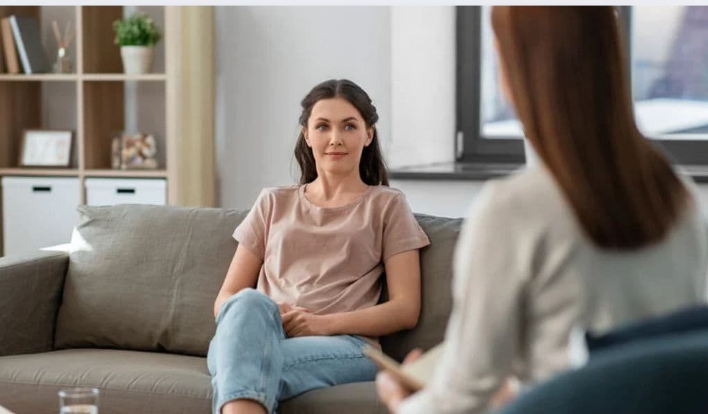 Mulher em sessão de terapia conversando com psicóloga